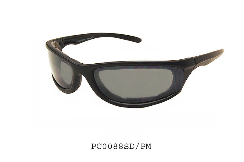 A pair of stylish motorcycle sunglasses with a sleek design, featuring super dark lenses for enhanced protection against sunlight. The frame appears sturdy and is designed for comfort during rides. The sunglasses are labeled as model PC0088SD/PM by APTCINC, suggesting a focus on specialty gear for motorcycle enthusiasts.