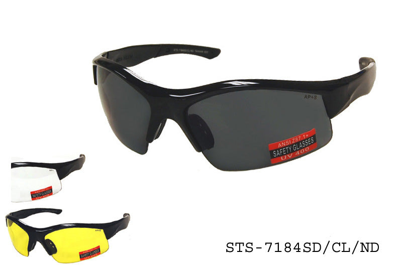 A pair of stylish safety sunglasses with a sleek design, featuring a clear lens suitable for driving. The frame is sturdy and designed for durability in various environments. The product is branded as STS-7184SD/CL/ND by APTCINC and is labeled as a specialty safety eyewear model.
